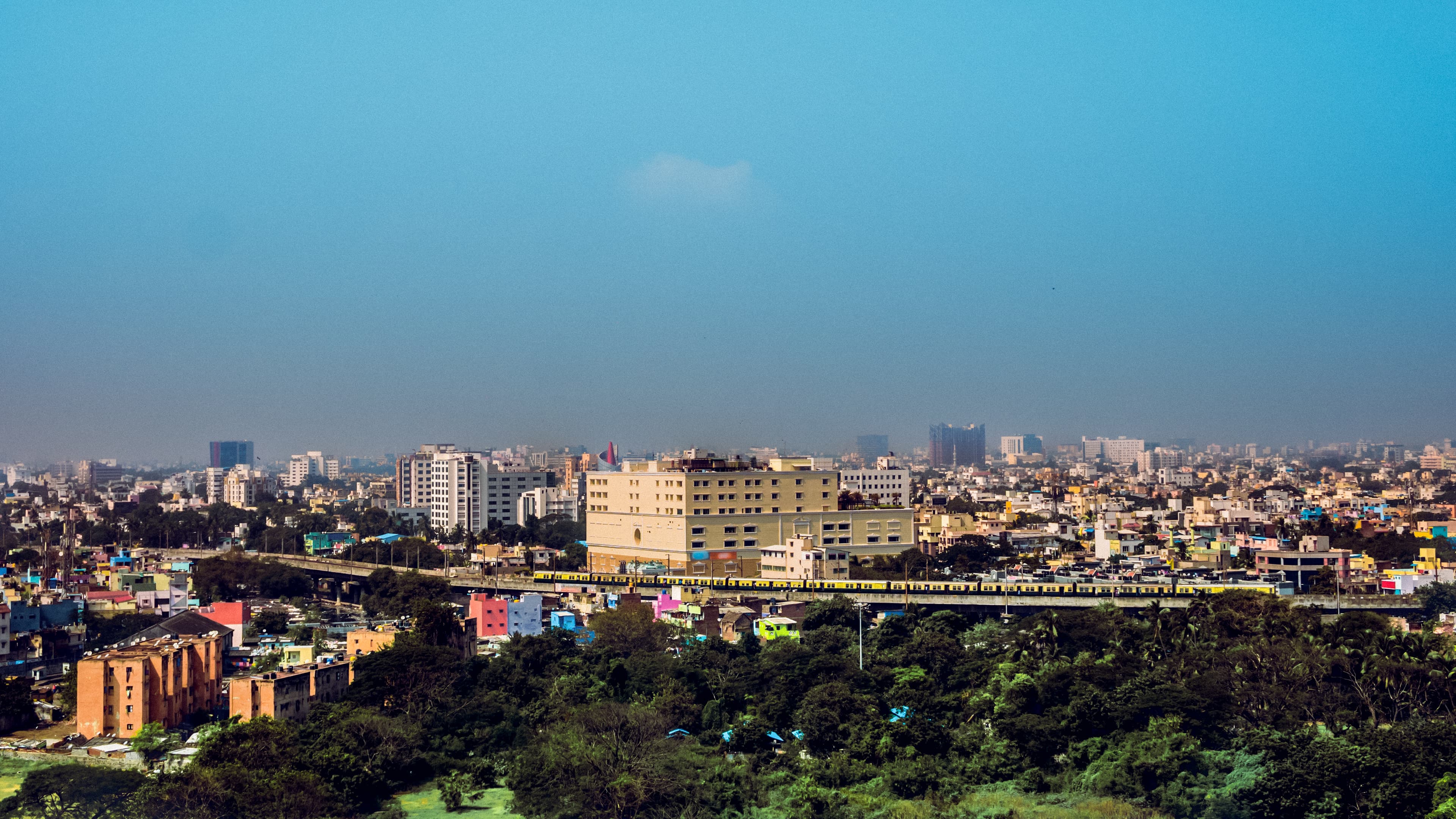 A panoramic view of Chennai, showcasing the city's expansive skyline with a mix of urban buildings, greenery, and infrastructure, illustrating its dynamic growth and development.